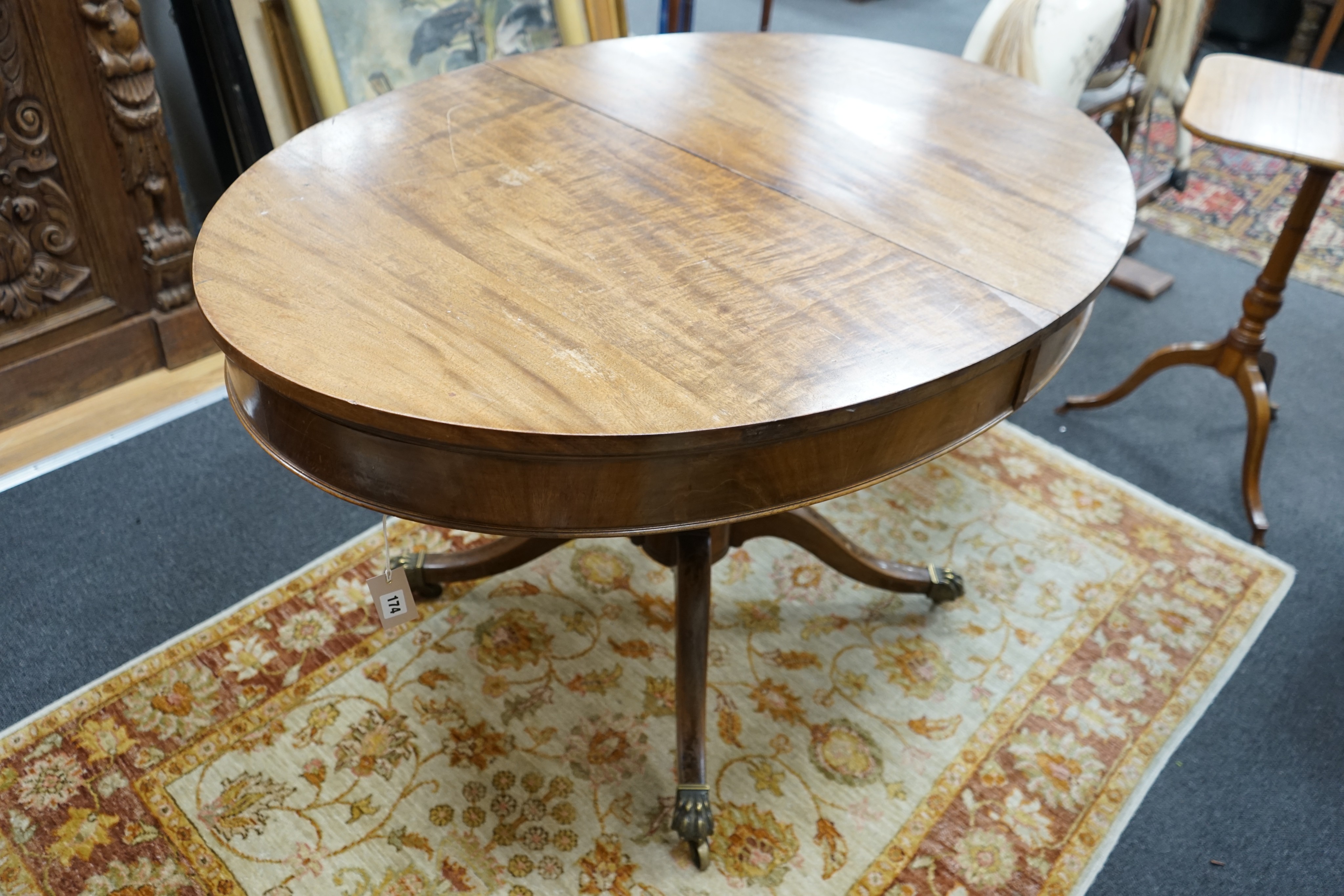 A small George III style oval mahogany extending dining table, (no leaves) width 126cm, depth 91cm, height 77cm